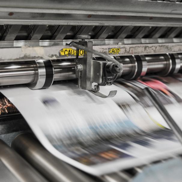 Paper going through a printing press